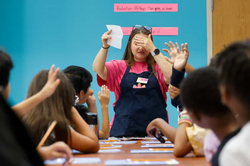 Penny Sessions, an instructor at the Fort Worth Science and History Museum, closes her eyes...