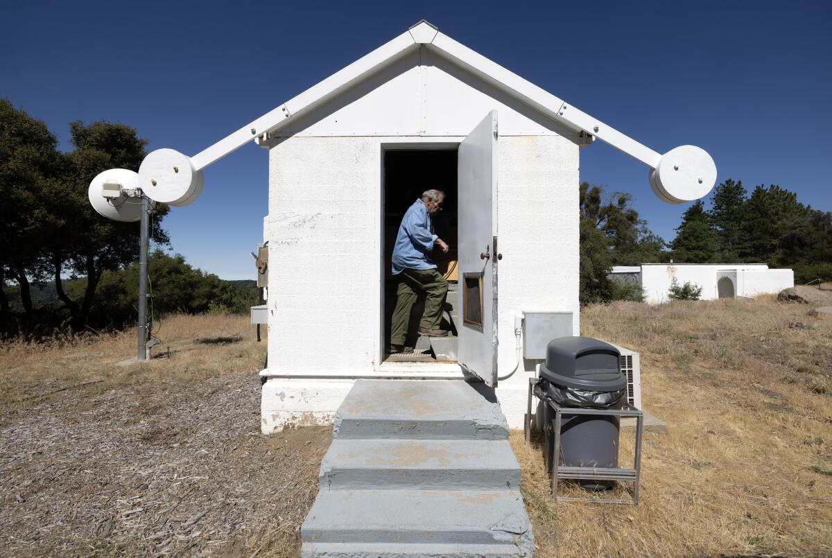 Steve Flanders enters a small building on the grounds of the Palomar Observatory where the Gattini-IR telescope is installed.