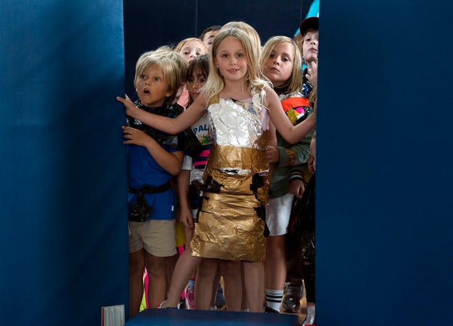 Ophelia Harper, 7, center, waits her turn to walk during the Funky Fashion show during Camp Palm Beach at the Mandel Recreation Center July 10, 2024. Children ages 5 to 8 were created to look use trash bags and duct tape.  The last day of the camp is July 26, 2024.