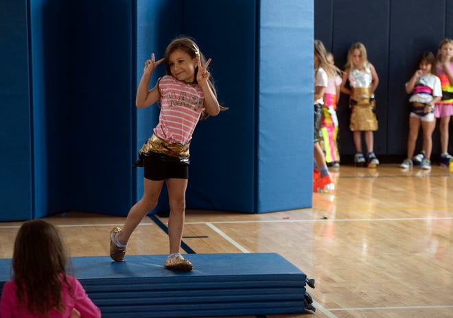 Sofia Radana, 6, shows off her gold tapestry look during the Funky Fashion show during Camp Palm Beach at the Mandel Recreation Center July 10. 2024. Children ages 5 to 8 created using garbage bags and duct tape.  The last day of the camp is July 26, 2024.