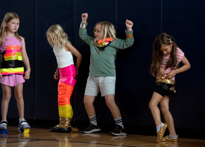 Caroline Morton, 7, from left, Stella Harper, 5, Lucien Hall, 7, and Sofia Radana, 6, participate in the Funky Fashion show during Camp Palm Beach at the Mandel Recreation Center July 10, 2024 .5 to 8 year olds look using garbage bags and duct tape.  The last day of the camp is July 26, 2024.