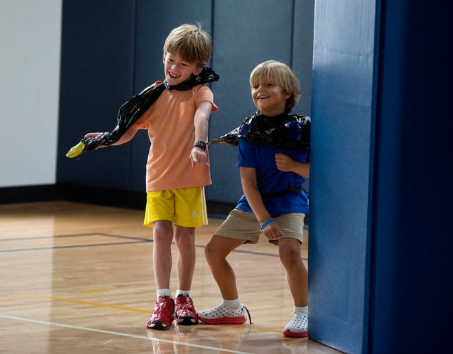 Charlie Colamarino, 6, from left, and Neill Morin, 6, dance during the Funky Fashion show during Camp Palm Beach at the Mandel Recreation Center July 10, 2024. Children ages 5 to 8 created a scene using garbage bags and duct tape.  The last day of the camp is July 26, 2024.