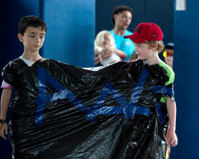 Ari Goodboy, 7, left, and William Maass, 7, wear a trash bag during the Funky Fashion show during Camp Palm Beach at the Mandel Recreation Center July 10, 2024. Children ages 5 to 8 created using trash bags and duct tape.  The last day of the camp is July 26, 2024.